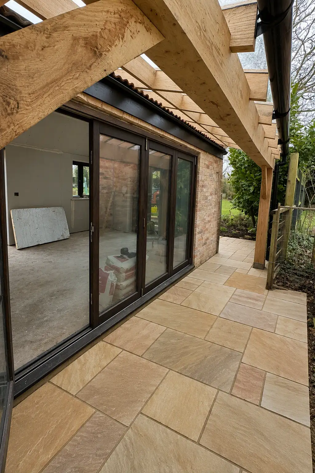 Oak frame and sliding doors onto a sandstone patio